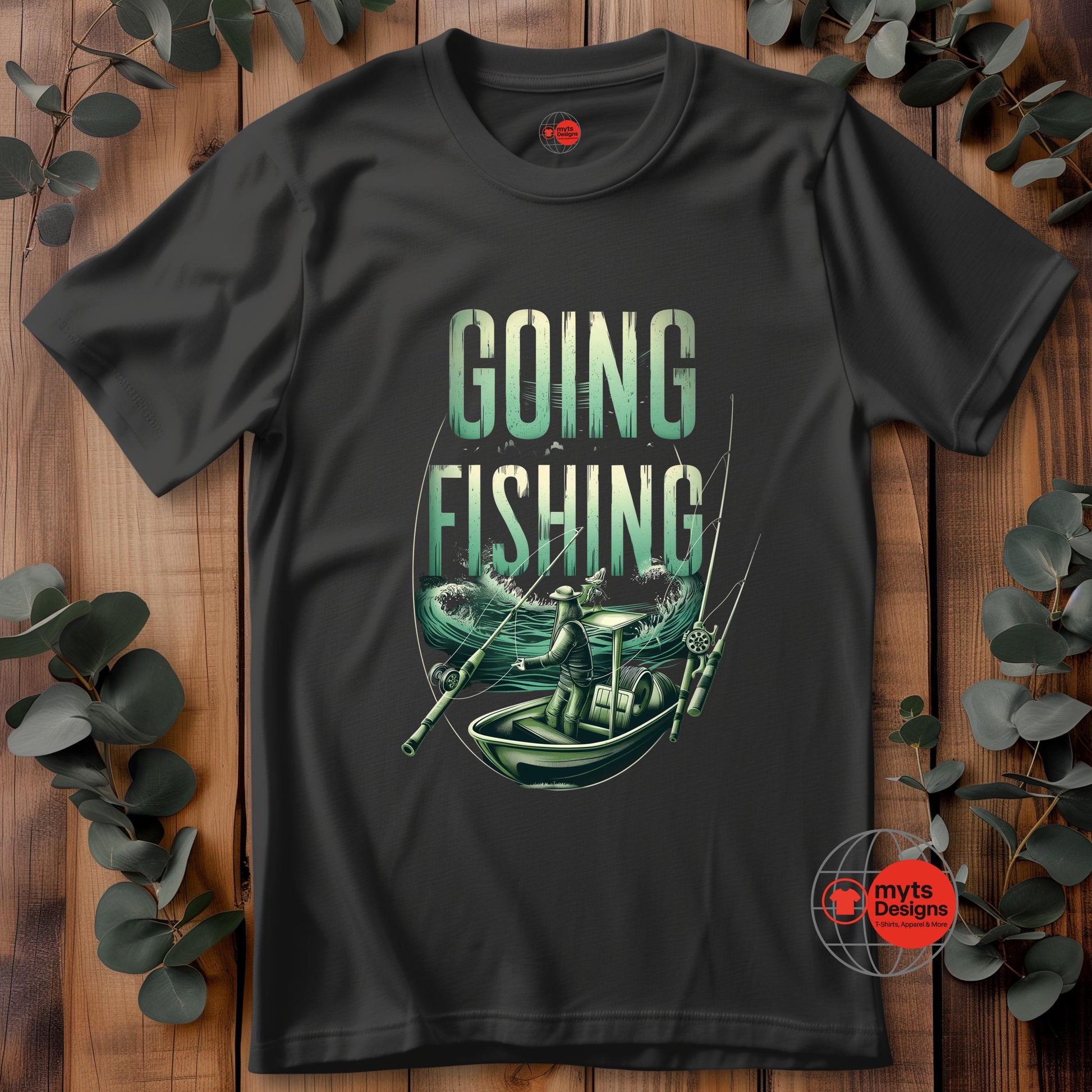 Black t-shirt with 'Going Fishing' graphic design on a wooden surface with eucalyptus leaves.