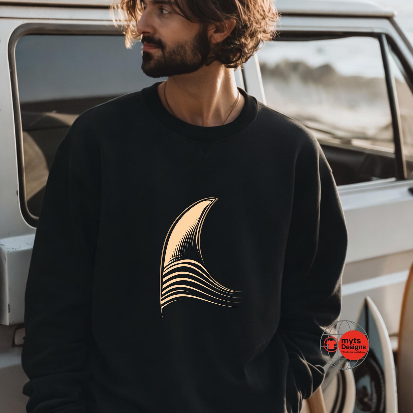 Man wearing a black sweatshirt with a gold design, standing next to a vehicle.