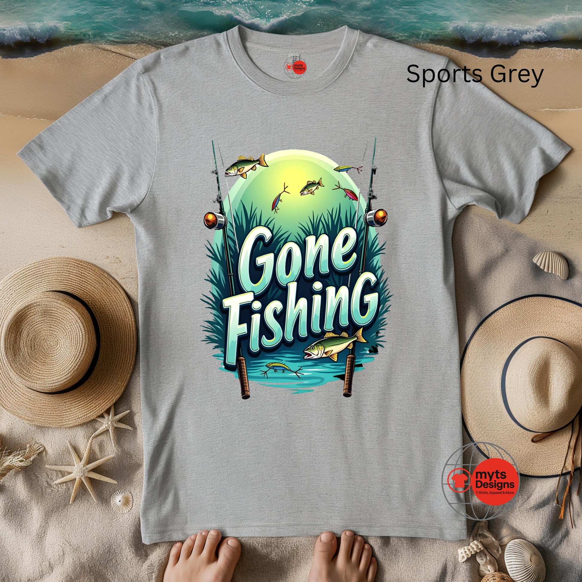 Gray t-shirt with 'Gone Fishing' graphic on a sandy background with hats and shells.