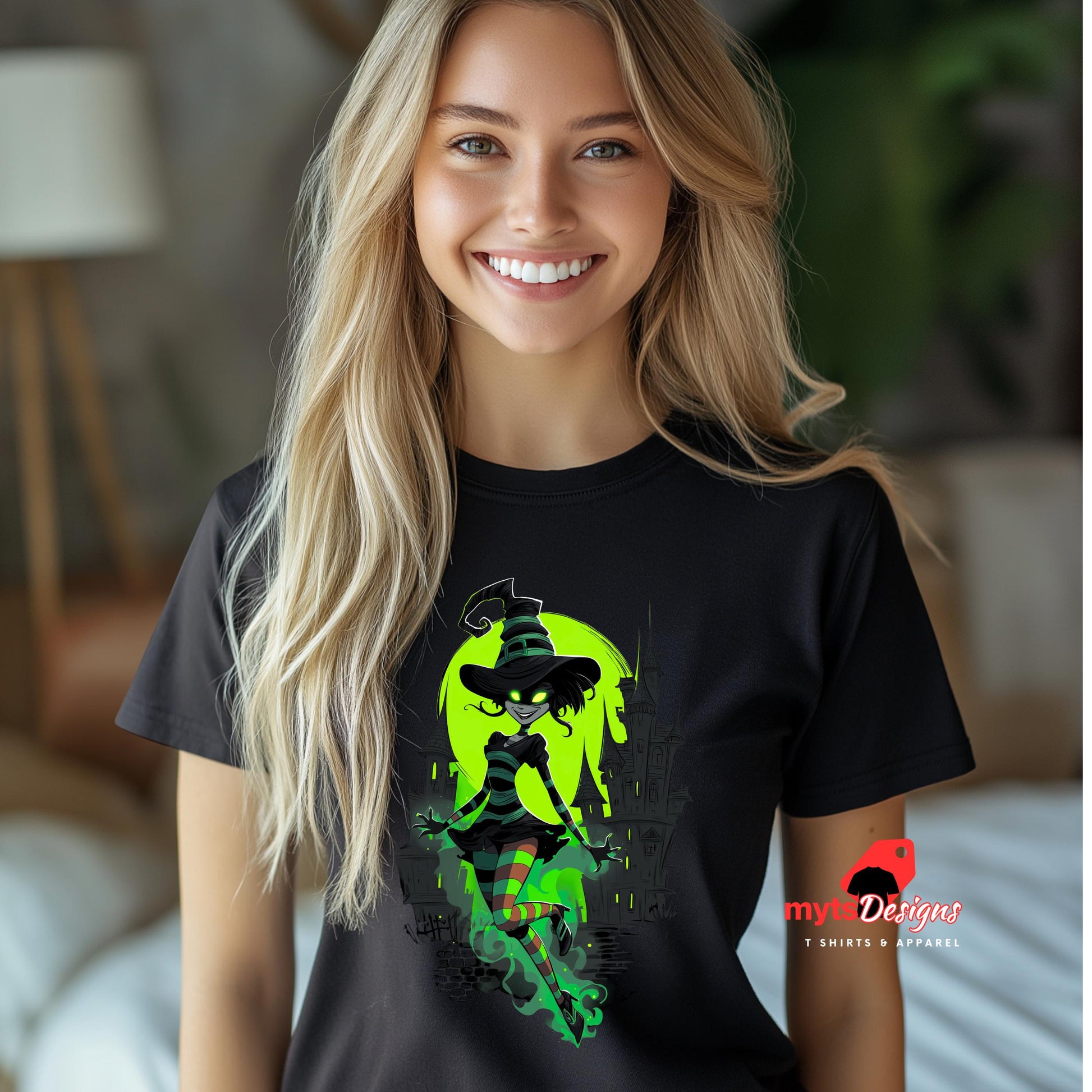 Woman wearing a black t-shirt with a colorful graphic design, standing in a room.