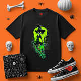 Black t-shirt with witch graphic on an orange background with Halloween-themed accessories.