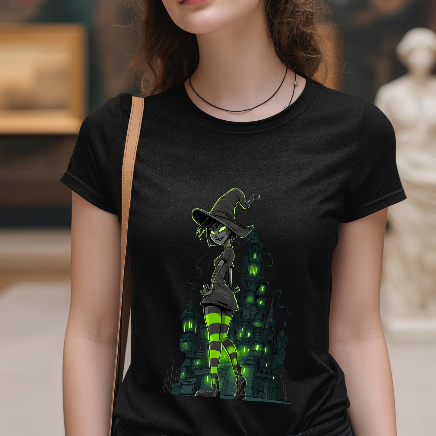 Person wearing a black t-shirt with a witch graphic design.