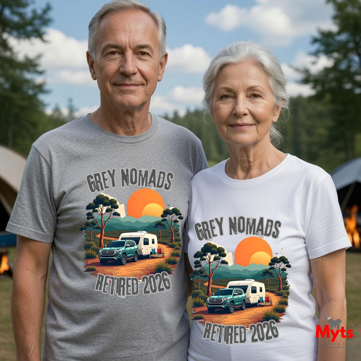 An older couple standing outdoors wearing matching graphic T-shirts. The shirt design reads 'GREY NOMADS RETIRED 2026' with an illustrated campsite scene featuring a green truck, white camper, trees, and an orange sunset.