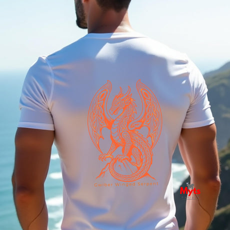 A man viewed from behind wearing a white short-sleeve t-shirt with a large orange dragon graphic on the back, set against a coastal background.