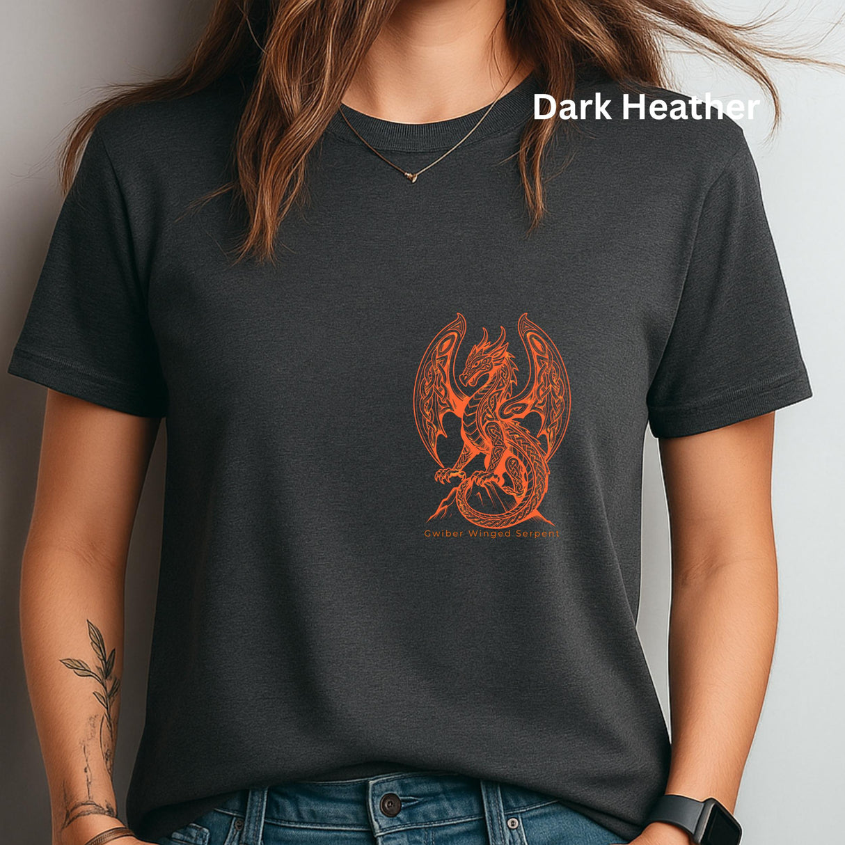 A woman wearing a dark heather charcoal t-shirt with an orange dragon graphic on the front. The text 'Dark Heather' is visible in the top right corner, indicating the fabric color.
