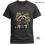A dark heather gray t-shirt featuring a graphic of a raccoon holding a bouquet of wildflowers. The text 'Dark Heather' is displayed in the top right corner, and the 'Myts' brand logo is visible on the inner neck label and as a watermark in the bottom right corner.