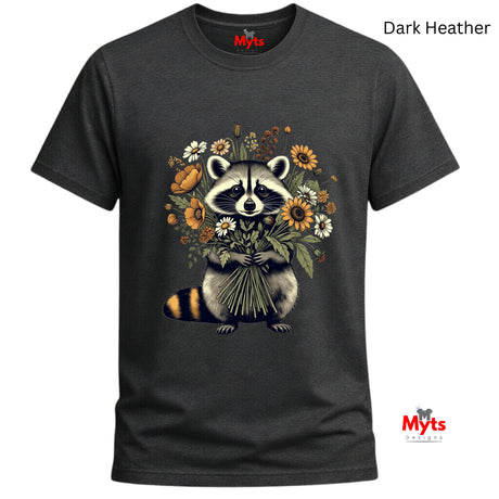 A dark heather gray t-shirt featuring a graphic of a raccoon holding a bouquet of wildflowers. The text 'Dark Heather' is displayed in the top right corner, and the 'Myts' brand logo is visible on the inner neck label and as a watermark in the bottom right corner.