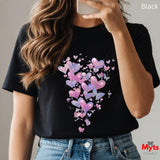 Woman wearing black t-shirt with glitter hearts and butterflies graphic featuring sparkling pink, purple, and blue hearts with delicate butterflies