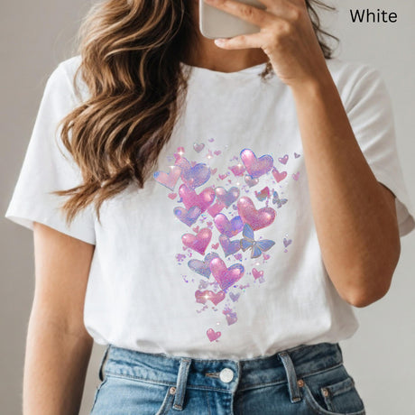 White t-shirt with colorful heart and butterfly design worn by a person.