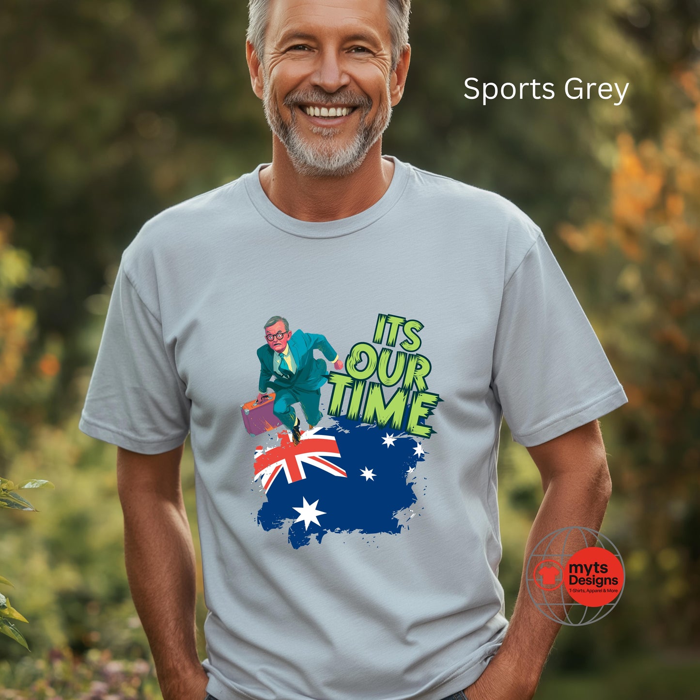 A man wearing a grey sports t-shirt with a graphic design and text, standing outdoors.