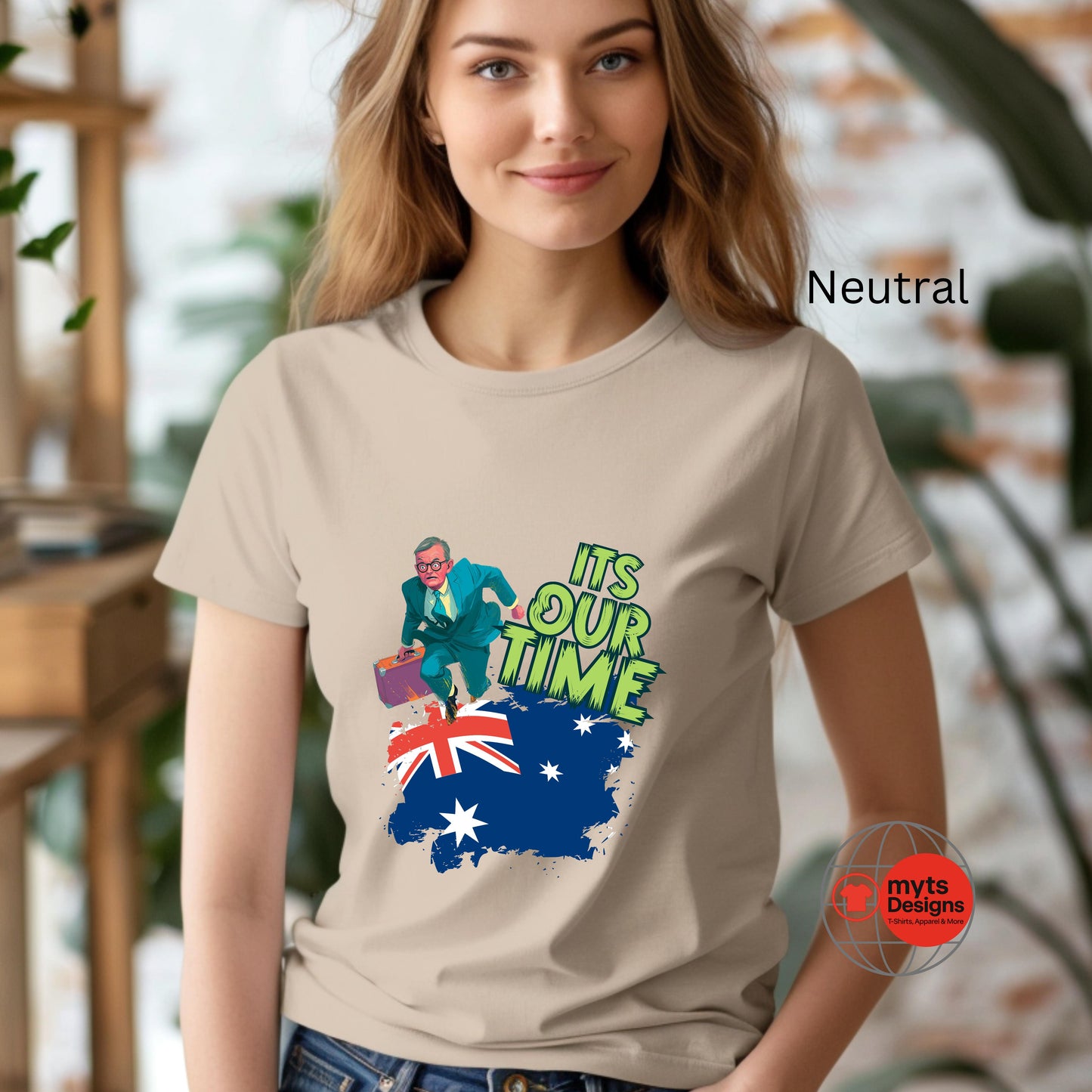 A woman wearing a Neutral t-shirt with a graphic design and text, standing indoors.
