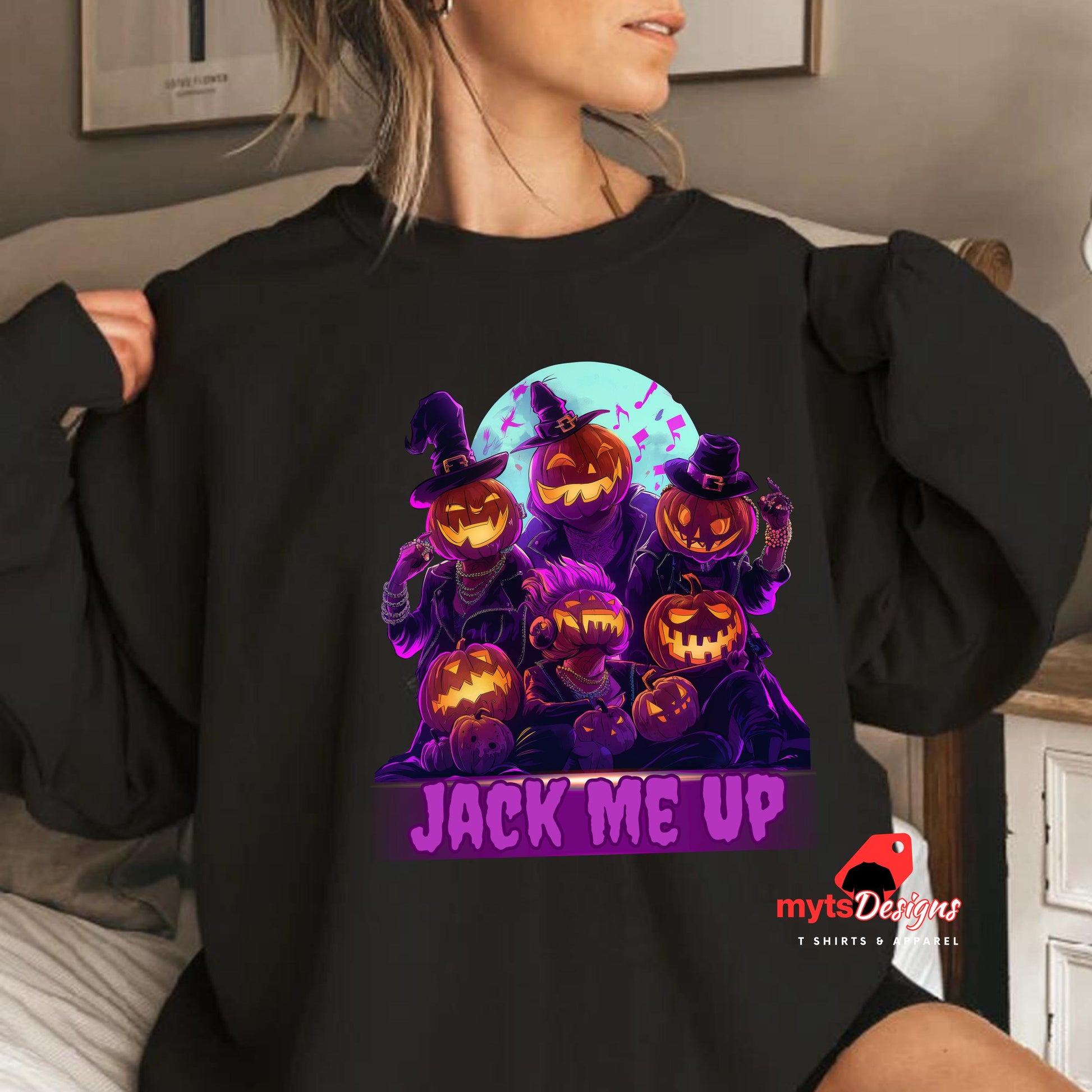 Person wearing a black sweatshirt with Halloween-themed design featuring pumpkins and text 'Jack Me Up'.