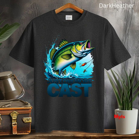 Black t-shirt with a fish graphic and 'CAST' text on a wooden surface with plants and a suitcase.