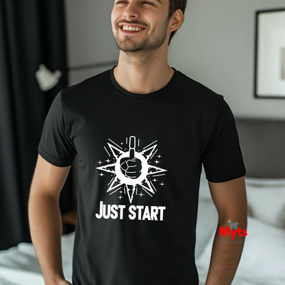 Man wearing a black t-shirt with a white graphic and text 'JUST START' in a bedroom setting.