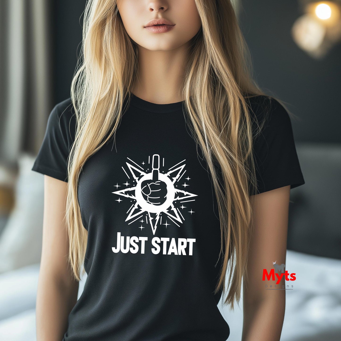 Person wearing a black t-shirt with a white graphic and text 'JUST START' in an indoor setting.