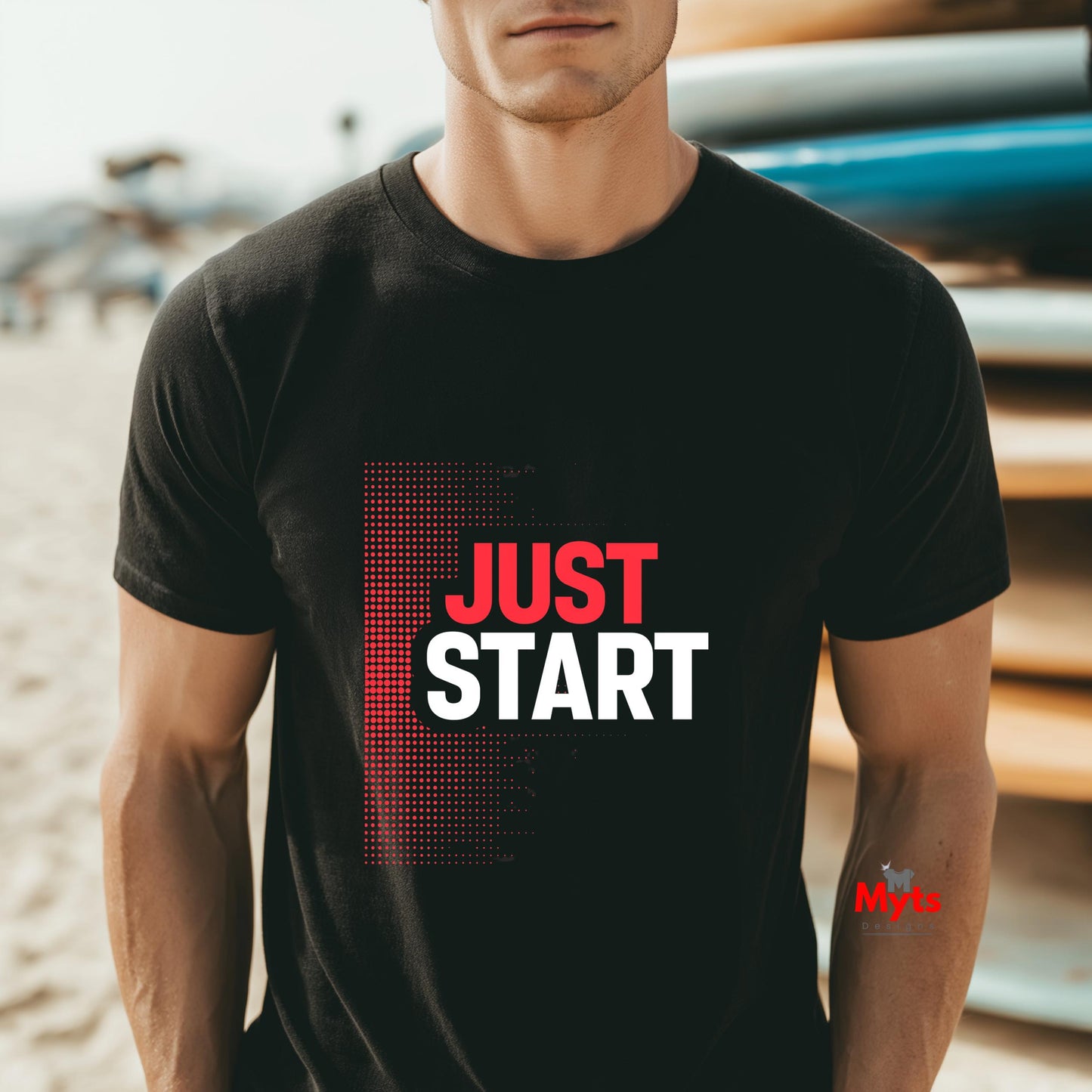 Man wearing a black t-shirt with 'JUST START' text on a beach.