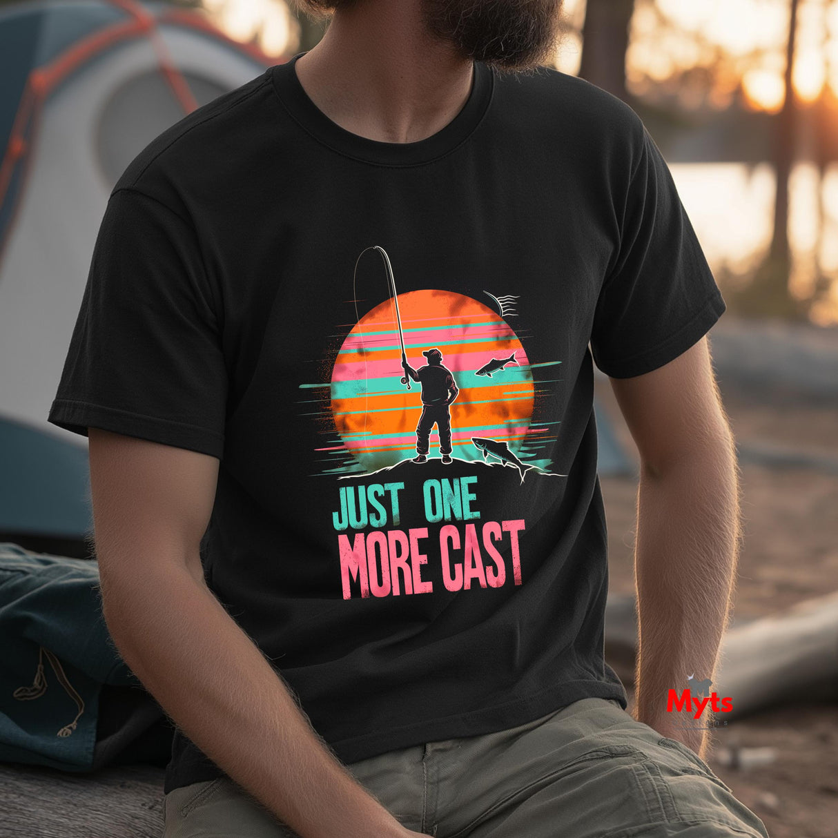 Person wearing a black t-shirt with a fishing graphic and text, sitting outdoors.