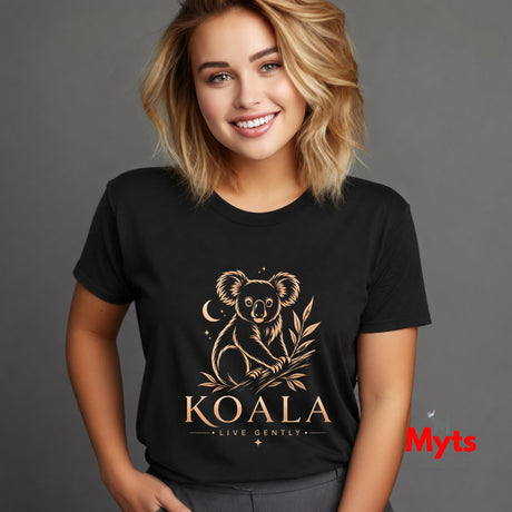 A smiling blonde woman wearing a black short-sleeve T-shirt with a gold koala graphic and the text 'KOALA LIVE GENTLY' on the front, photographed against a plain gray studio background.