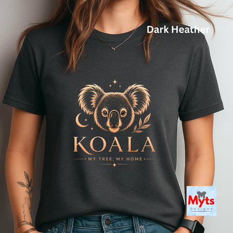 A woman wearing a dark heather charcoal t-shirt with a gold-colored koala graphic and the text 'KOALA MY TREE, MY HOME'. The image includes a 'Dark Heather' color label overlay and a 'Myts Designs' watermark logo on the bottom right.