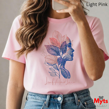 Person wearing a pink t-shirt with a colorful leaf design and 'Myts Designs' branding.