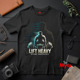 Black t-shirt with 'Lift Heavy, Become Unbreakable' graphic on a dark surface with accessories.