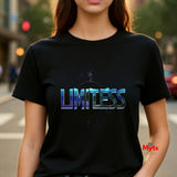 Person wearing a black t-shirt with 'LIMITLESS' printed on it, standing on a street.