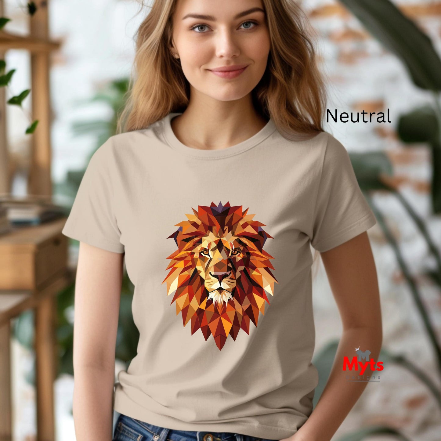 Woman wearing a beige t-shirt with a colorful lion graphic in an indoor setting.