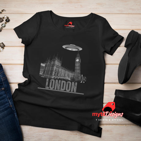 Front view of a black flat lay soft casual tee featuring London’s Big Ben and Parliament skyline with a stylized spaceship hovering above, printed on ultra-soft Gildan 64000 cotton.