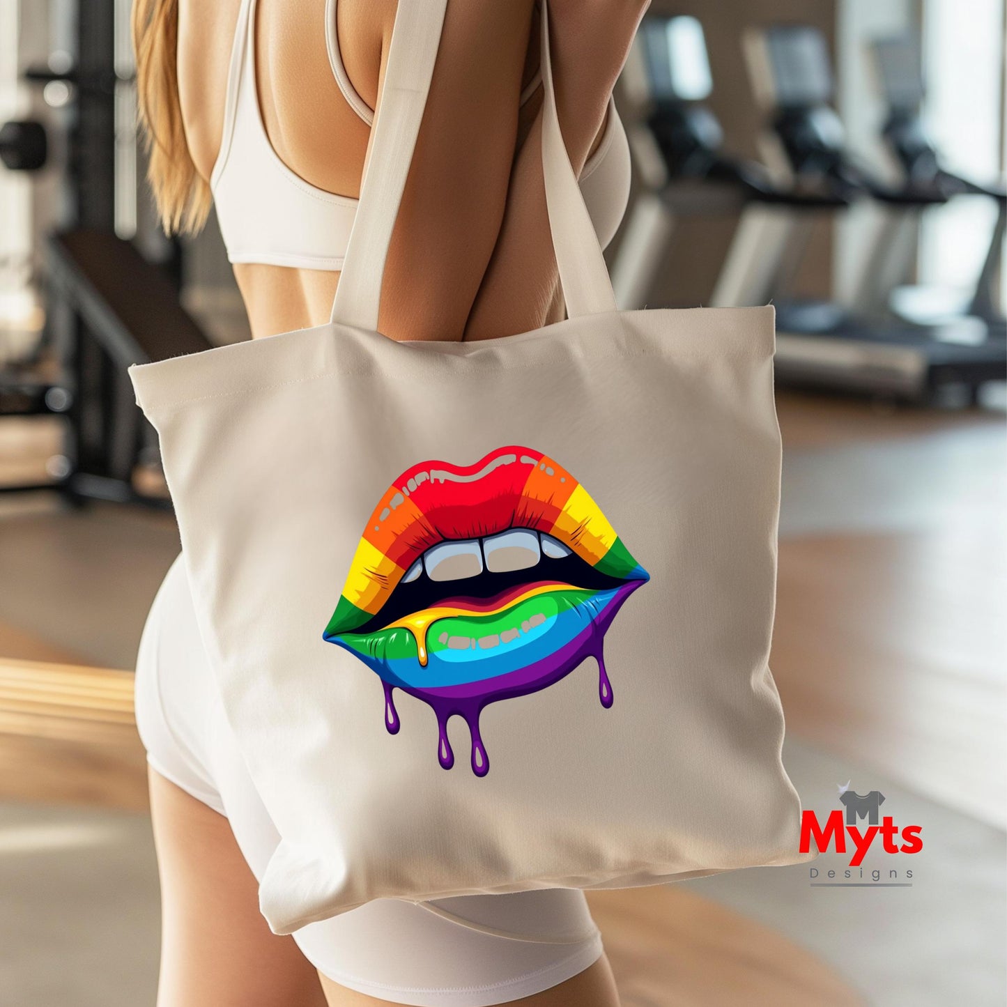 Person holding a tote bag with rainbow lips design in a gym setting