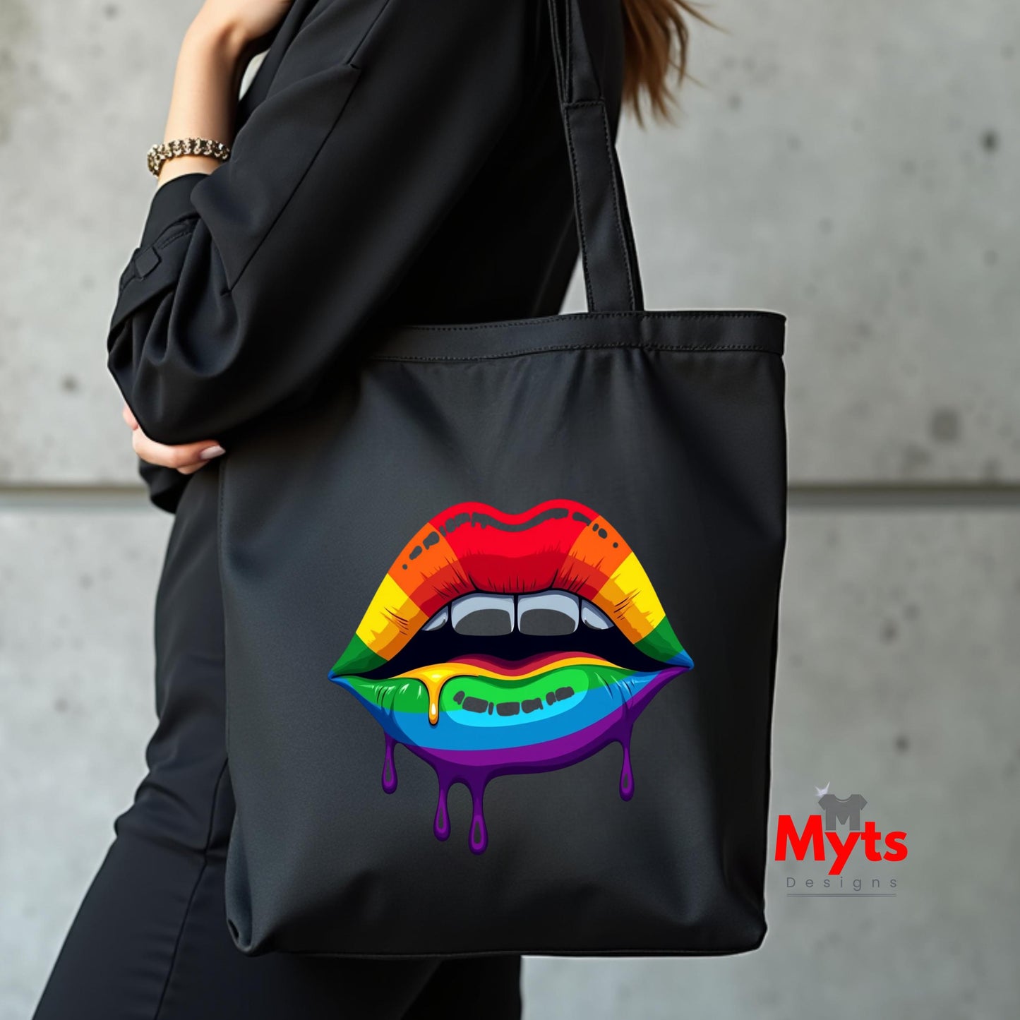 Black tote bag with rainbow lips design held by a person against a concrete wall, featuring the brand 'Myts'.