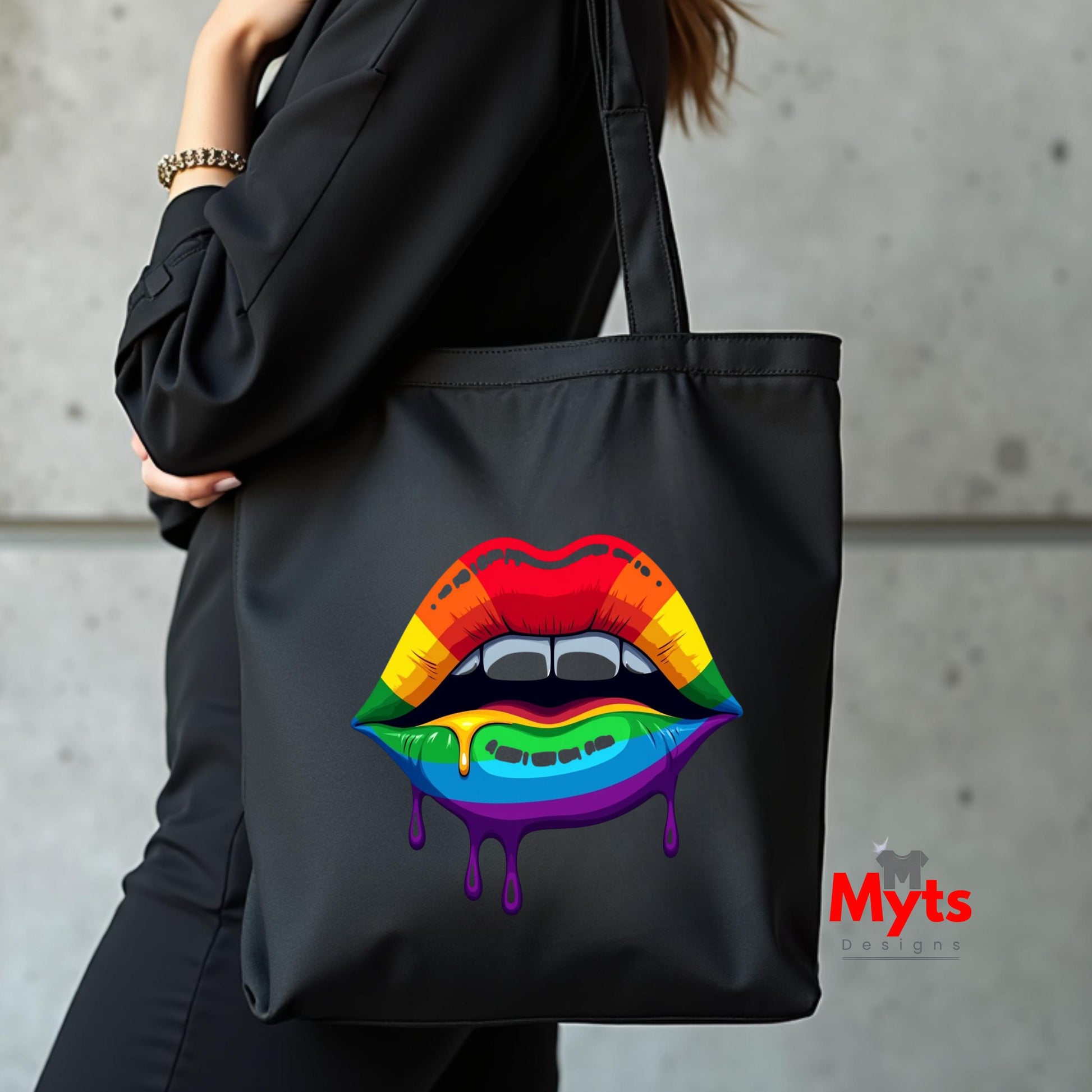 Black tote bag with rainbow lips design held by a person against a concrete wall, featuring the brand 'Myts'.