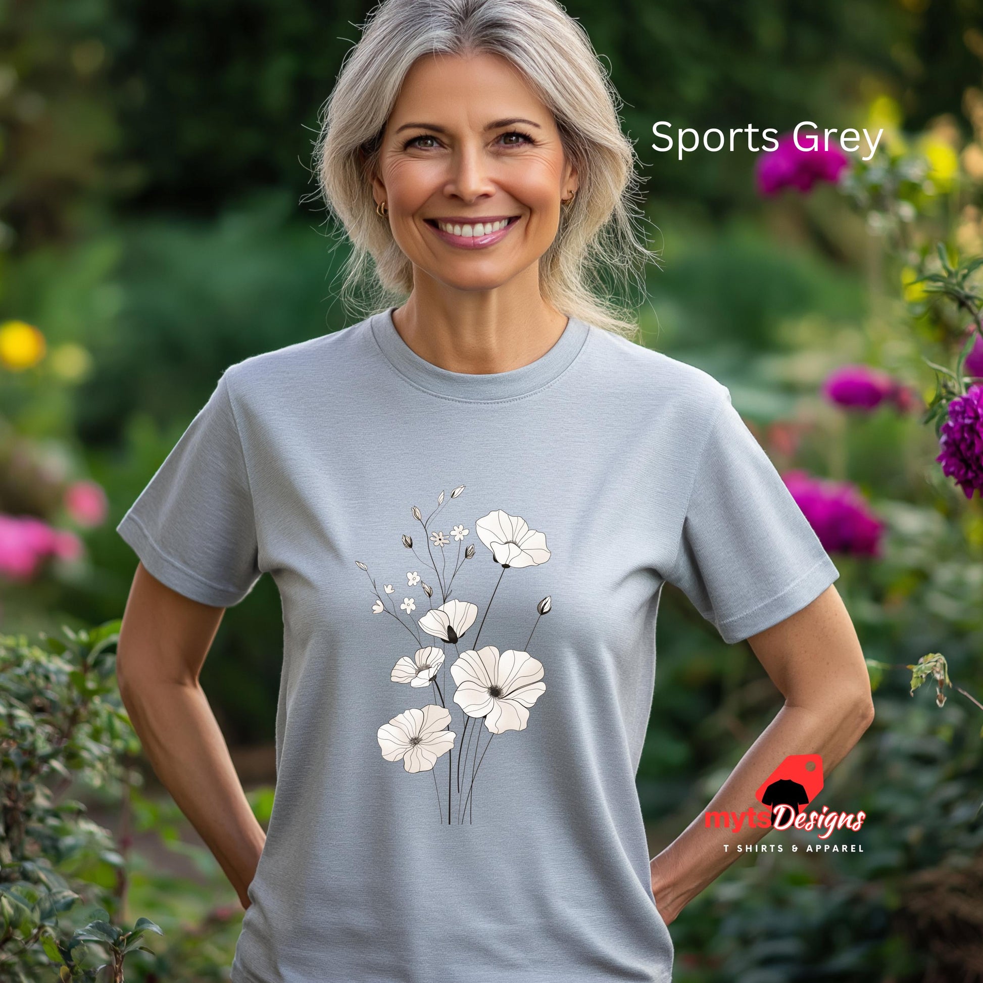 Woman wearing a light gray t-shirt with floral design in a garden setting