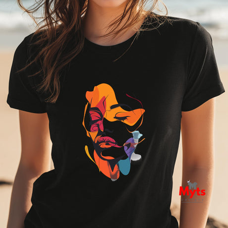 Person wearing a black t-shirt with a colorful graphic design on a beach.