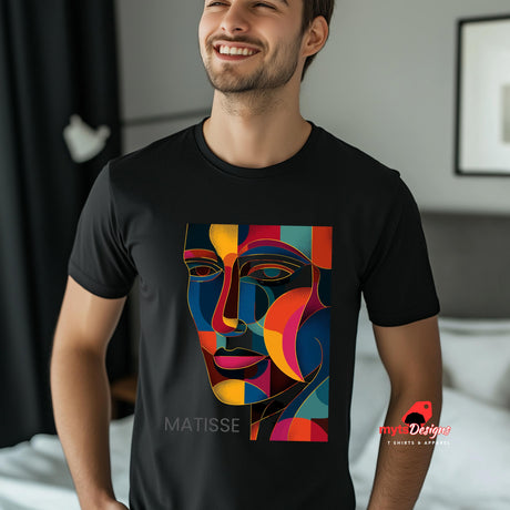 Man wearing a black t-shirt with a colorful face design and 'Matisse' text, standing in a room.