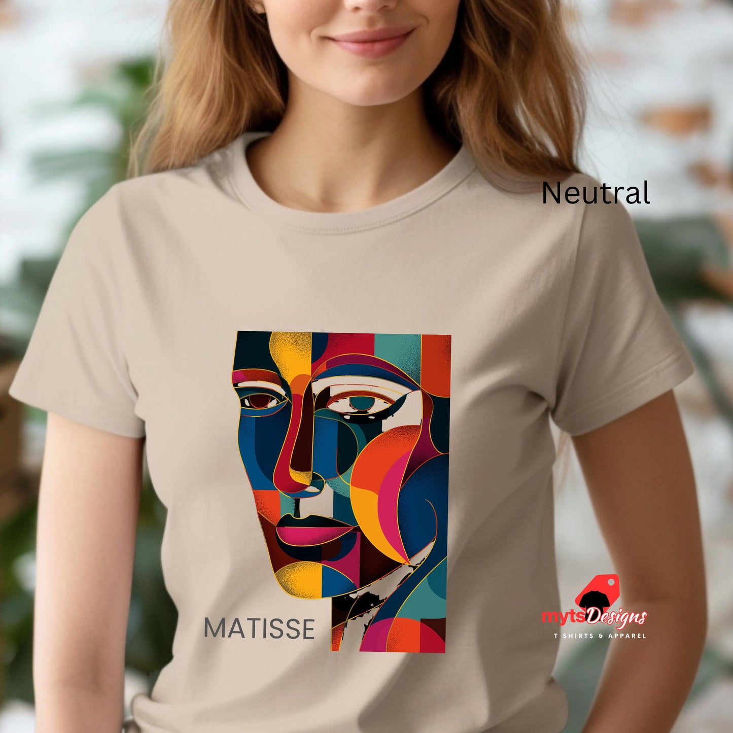 Person wearing a t-shirt with a colorful Matisse design and 'Matisse Designs' branding.