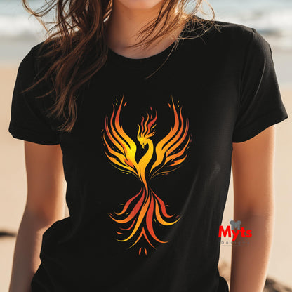 Person wearing a black t-shirt with a colorful phoenix design on a beach.