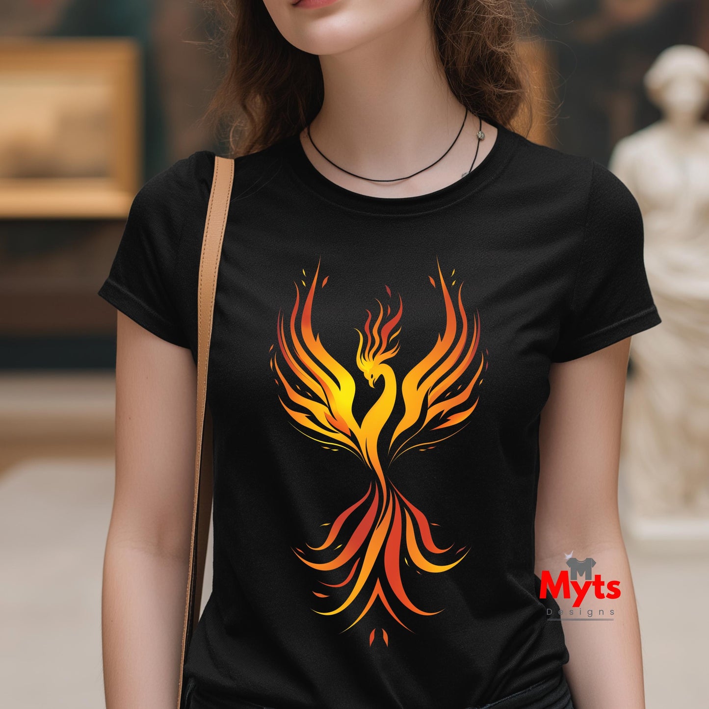 Person wearing a black t-shirt with a colorful phoenix design, standing indoors.