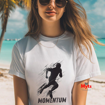 Woman wearing a white t-shirt with a black graphic and 'MOMENTUM' text on a beach.