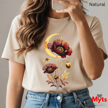 A woman wearing a beige short-sleeve t-shirt with a graphic print of two red poppy flowers, a gold crescent moon, and small gold butterflies. The image is a mirror selfie with the word 'Natural' in the top right corner and a 'Myts designs' watermark in the bottom right.