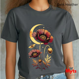 A person wearing a dark heather charcoal t-shirt with a detailed graphic of red poppy flowers, a crescent moon, and a bee. The text 'Dark Heather' is visible in the top right, and a 'Myts Designs' logo is in the bottom right corner.