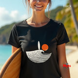 Person wearing a black t-shirt with a graphic design on a beach