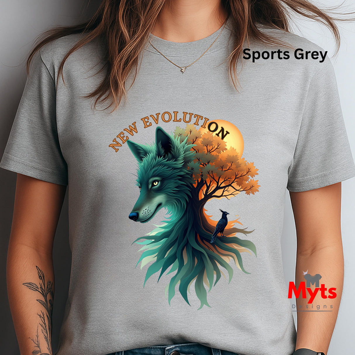 A woman wearing a light gray t-shirt with a colorful graphic of a wolf and tree. The text 'Sports Grey' is visible on the upper right, and a 'Myts designs' watermark is visible on the lower right.