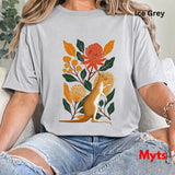 A woman wearing an oversized Ice grey t-shirt with a colorful graphic of a kangaroo surrounded by orange and yellow flowers and green leaves. The text 'Ice Grey' is visible in the top right corner, and 'Myts' is written in red in the bottom right corner.