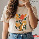 A woman wearing a Natural short-sleeve t-shirt with a colorful graphic of a kangaroo and flowers, paired with blue jeans. The image includes a 'Natural' label at the top right and a 'Myts designs' logo at the bottom right.