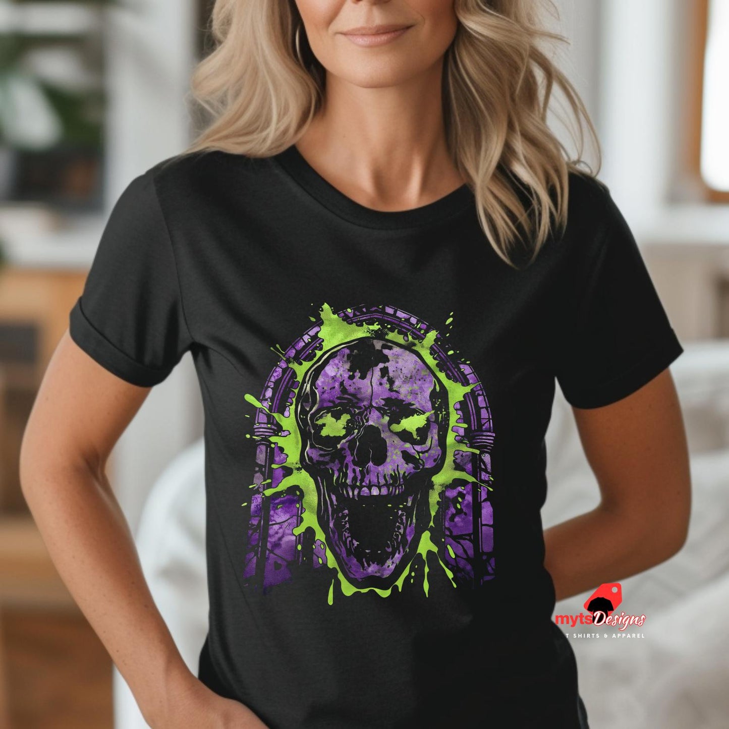 Person wearing a black t-shirt with a purple and green skull design.
