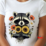 A white short-sleeve t-shirt featuring a detailed graphic print of a raccoon holding a bouquet of yellow sunflowers, orange poppies, and white daisies, shown on a model.