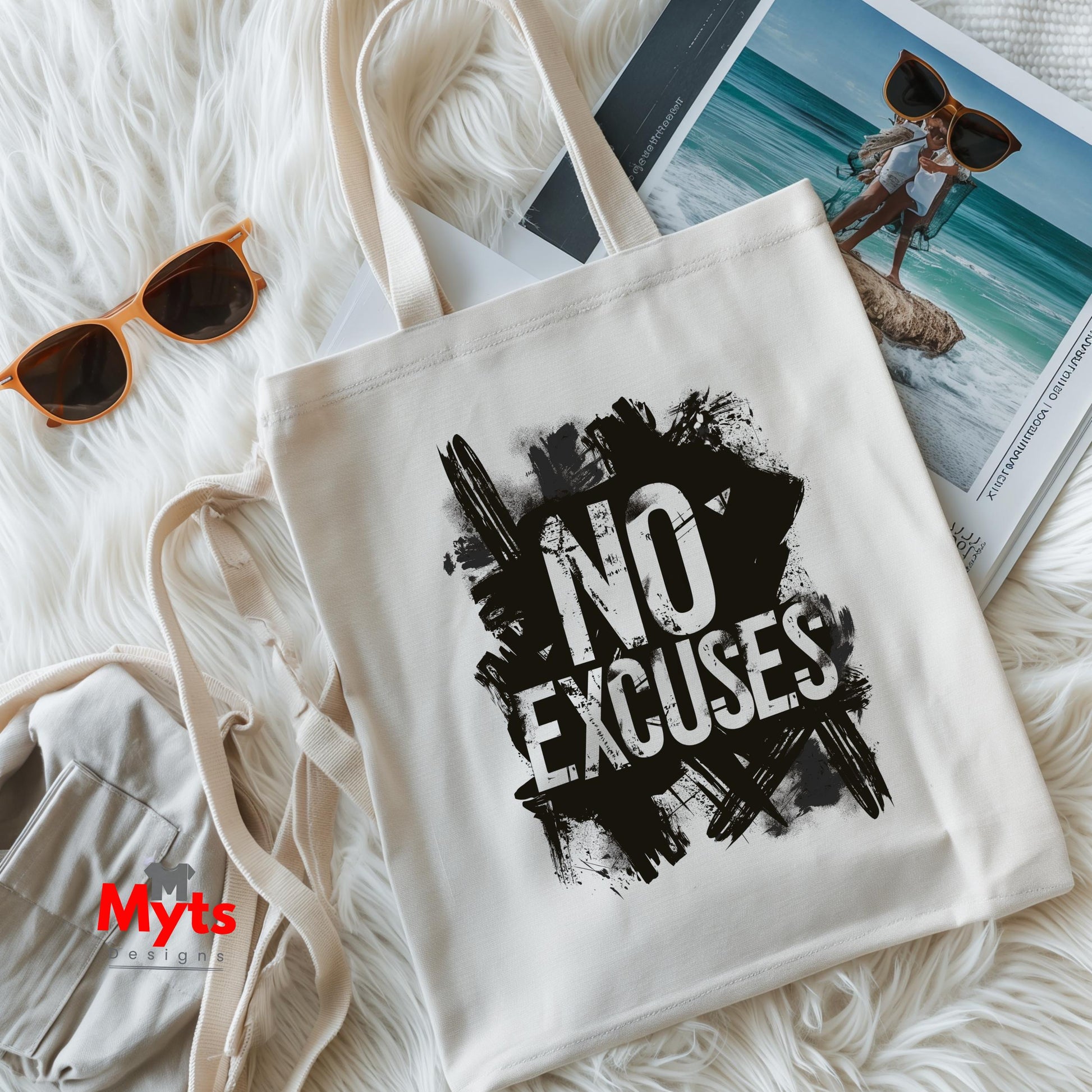 White tote bag with 'NO EXCUSES' text, sunglasses, and magazine on a white surface