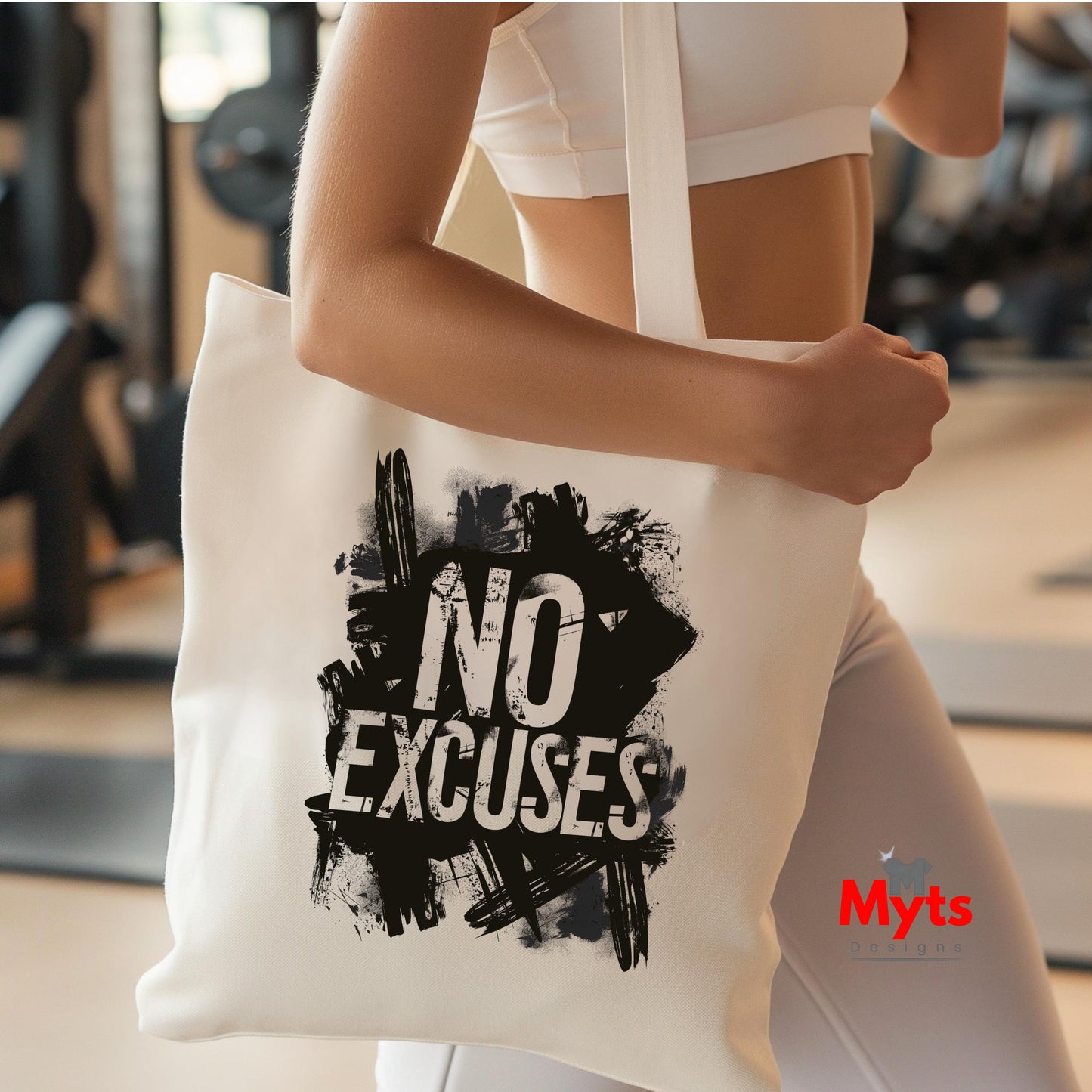 Person holding a tote bag with 'No Excuses' text in a gym setting