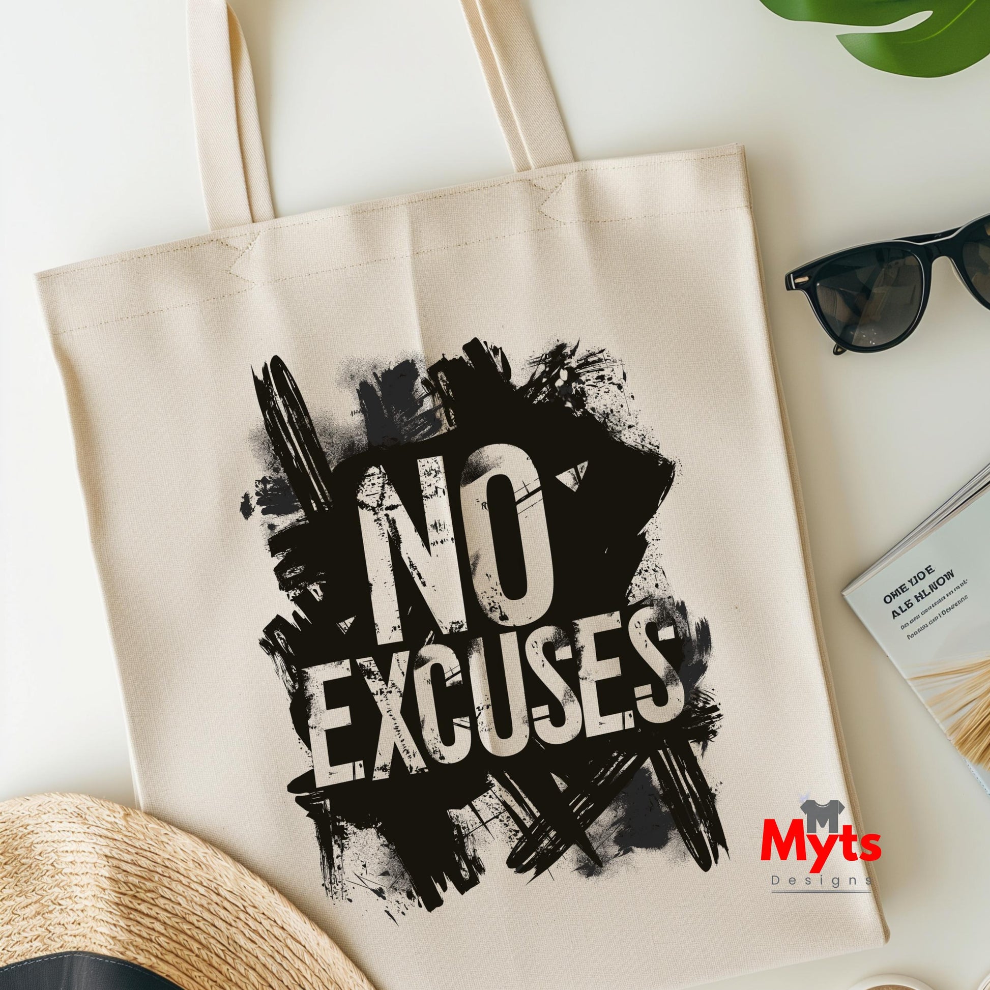 Beige tote bag with 'No Excuses' text and Myts logo on a light surface.