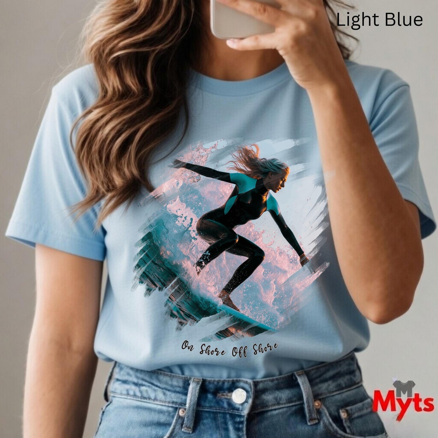 Person wearing a light blue t-shirt with a graphic design and 'Myts' branding.